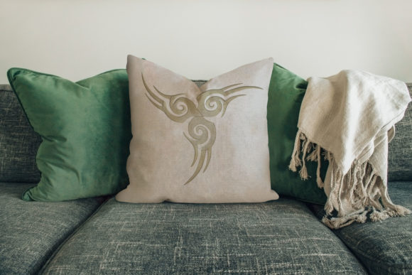 An Embroidery Designer Reviews Tattoo Design on Cushion